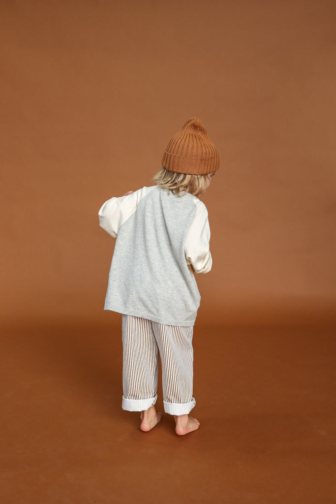 Gray and white long-sleeve tee for children. knitted from organic cotton, back view. Striped brown cotton pant